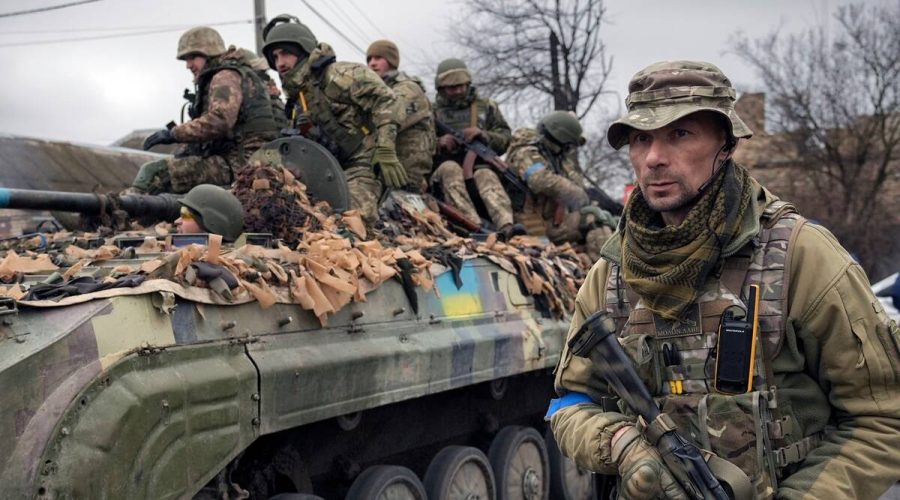 A+Ukrainian+serviceman+walks+next+to+a+fighting+vehicle%2C+outside+Kyiv%2C+Ukraine.+